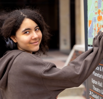 Student pointing to a map