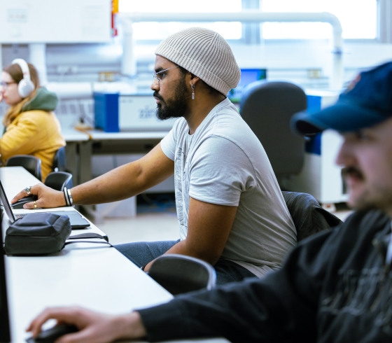 Three students working at computers