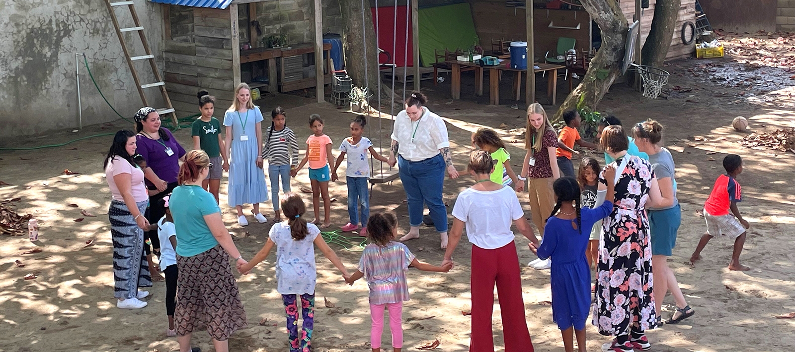 Children and teachers in a circle outside