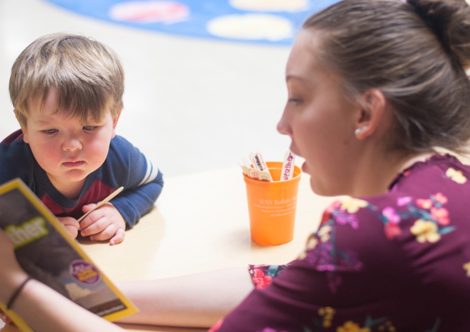 A woman reading to a child